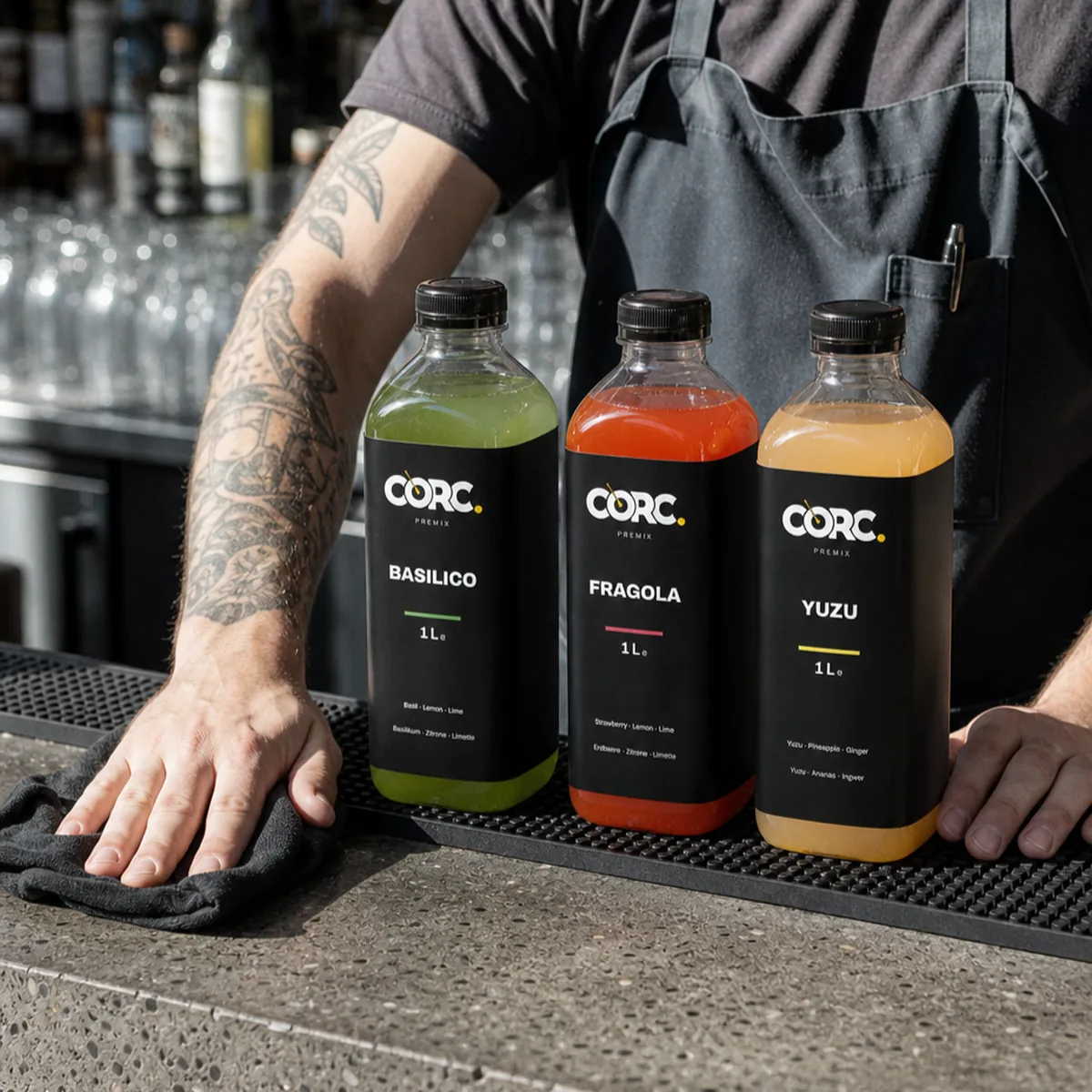 Bartender behind the counter with three CORC bottles